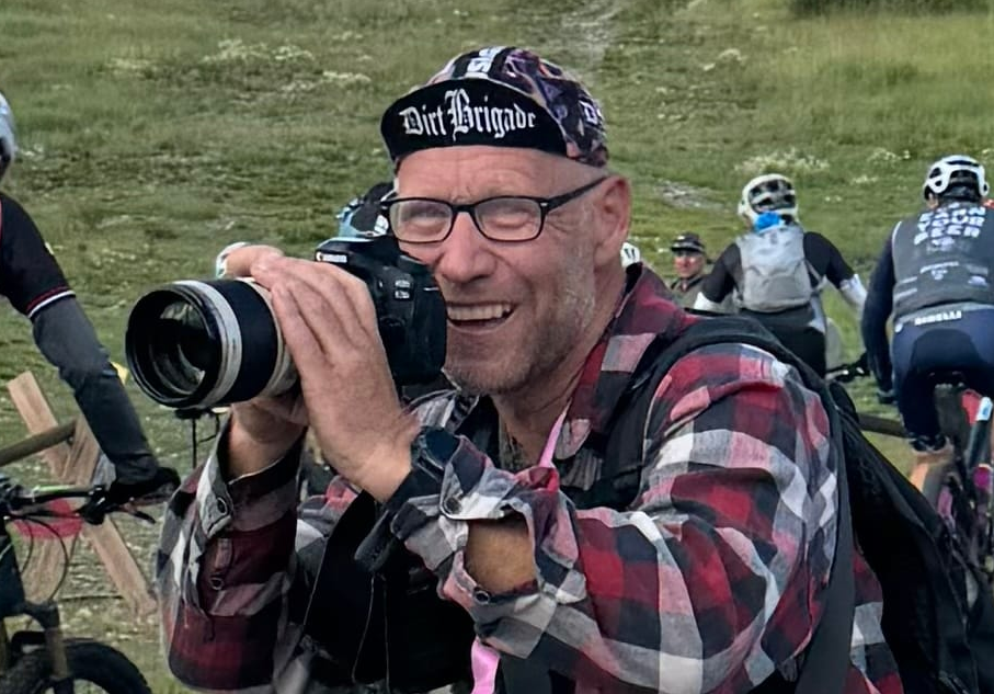 Photographer holding a camera on the trail at the Breck Epic mountain bike stage race in Breckenridge, Colorado.
